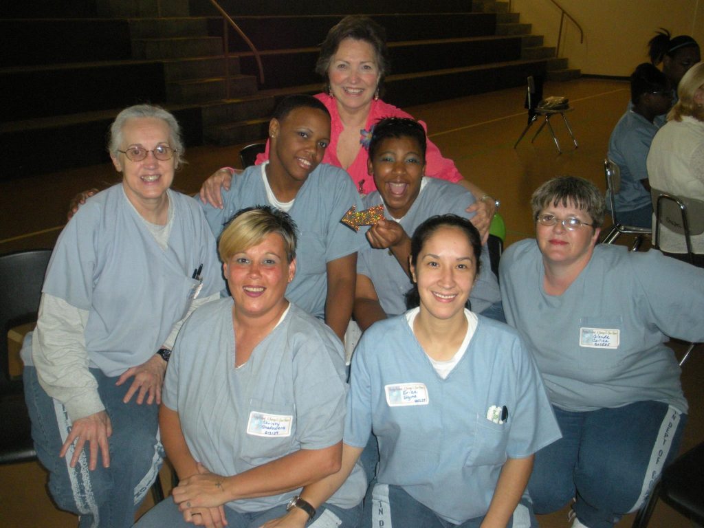 Linda Lee White (top), founder and executive director of Women Ablaze Ministries, with members of the prison ministry.