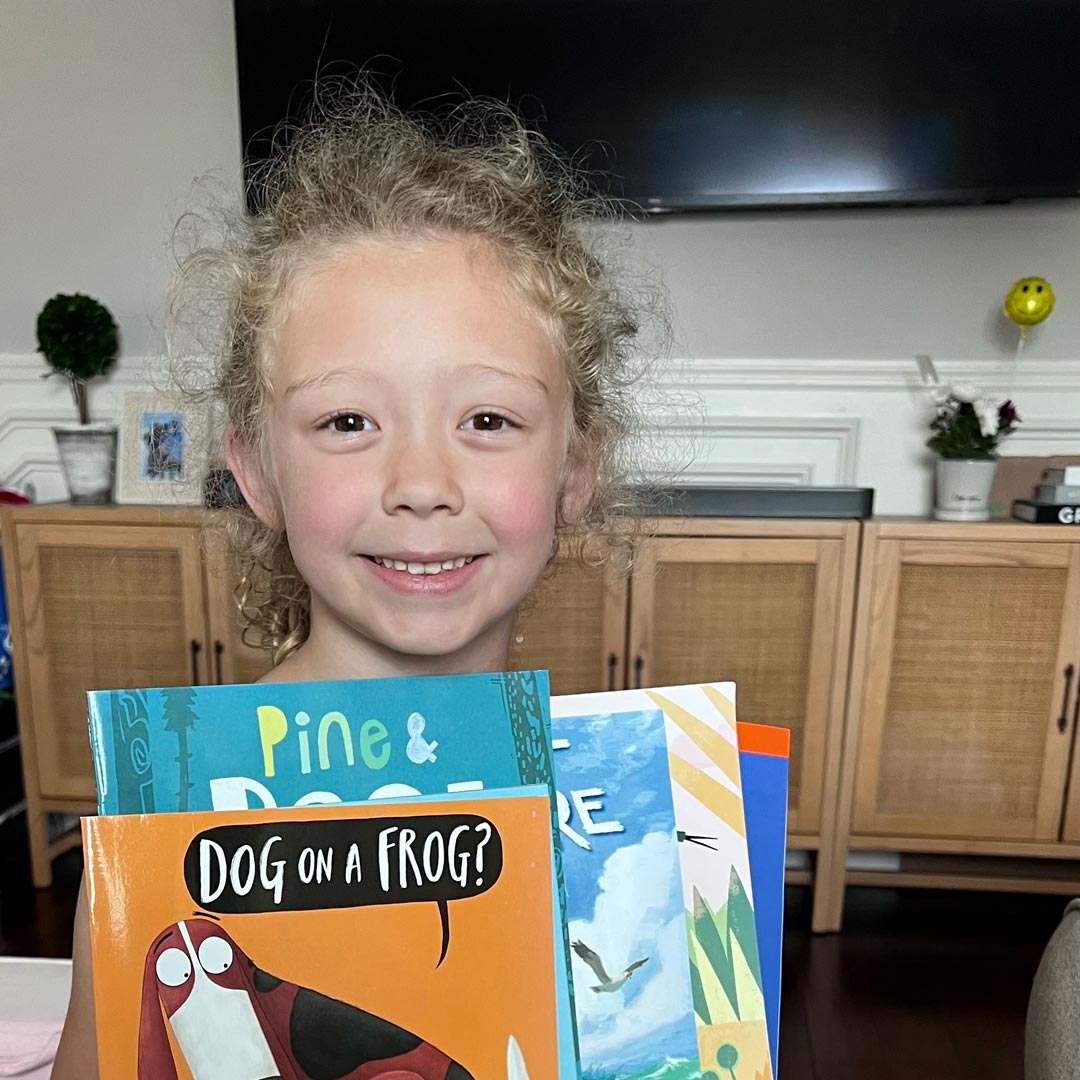 Young girl receives book pack